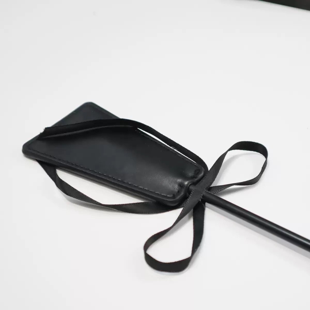 Feather Crop — Noir Rouge. Handmade full-grain leather paddle. UK bondage accessories for couples.
